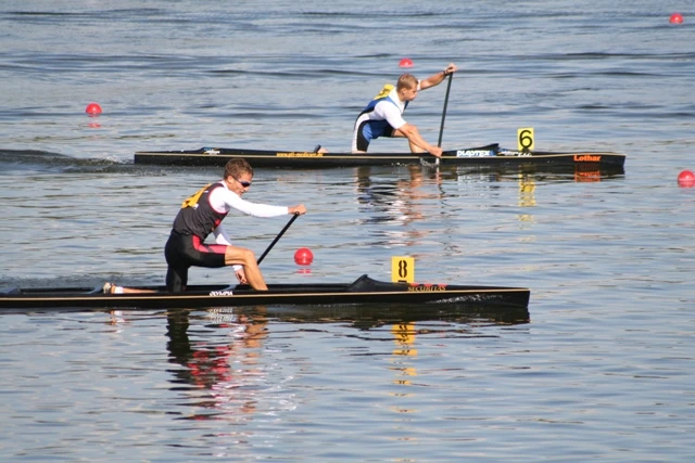 Zwei Kanuten paddeln auf dem Wasser.